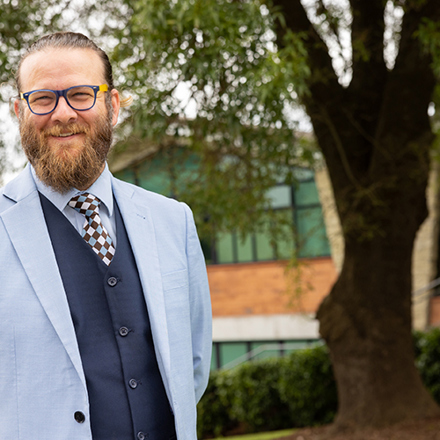 Director of Flourishing standing outside the Senior Campus gymnasium