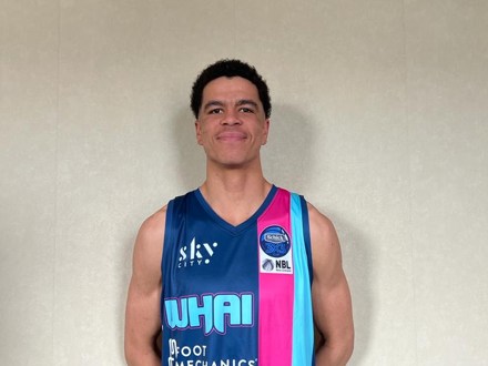 Dilworth Alumni standing in his basketball uniform 