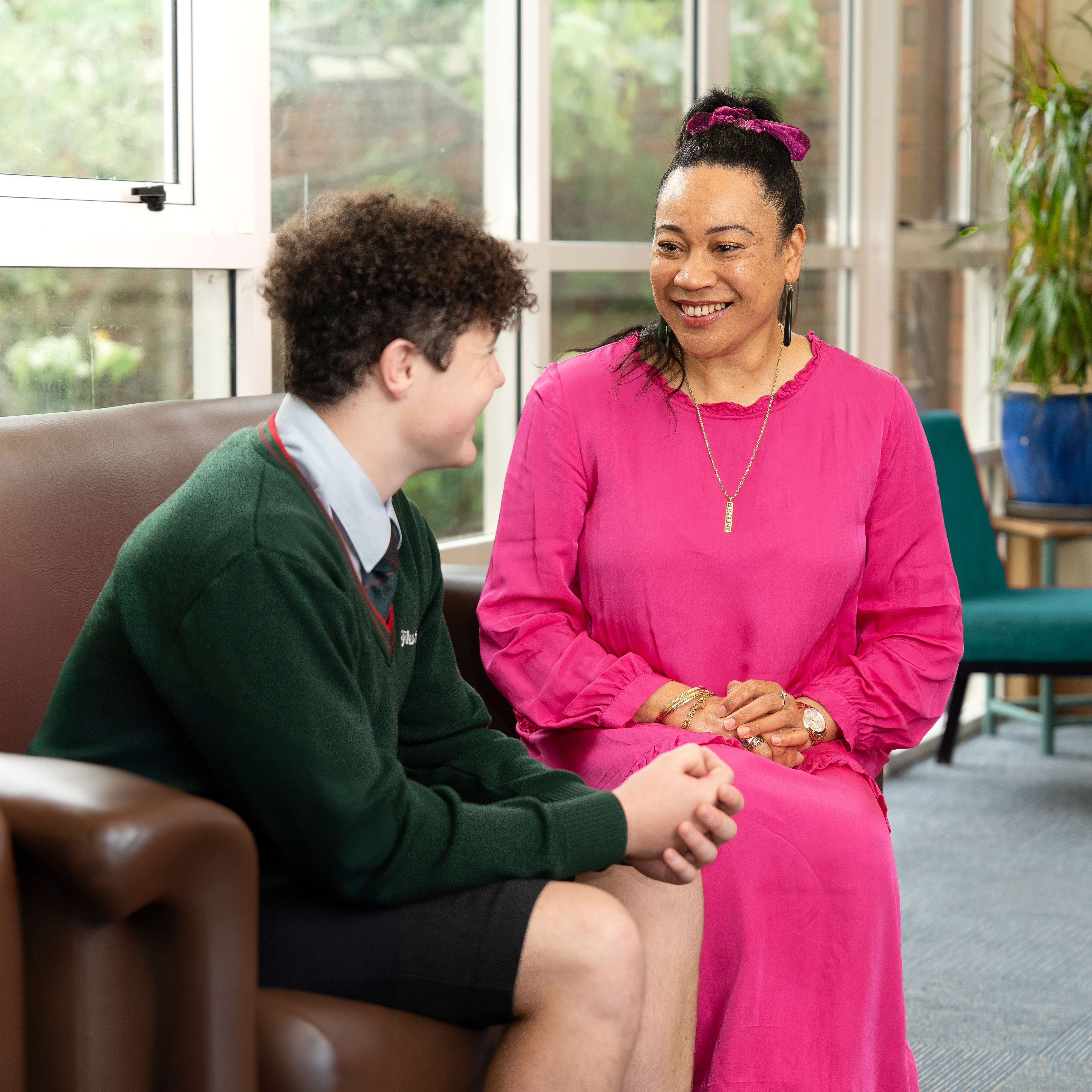 student talking to board house staff member