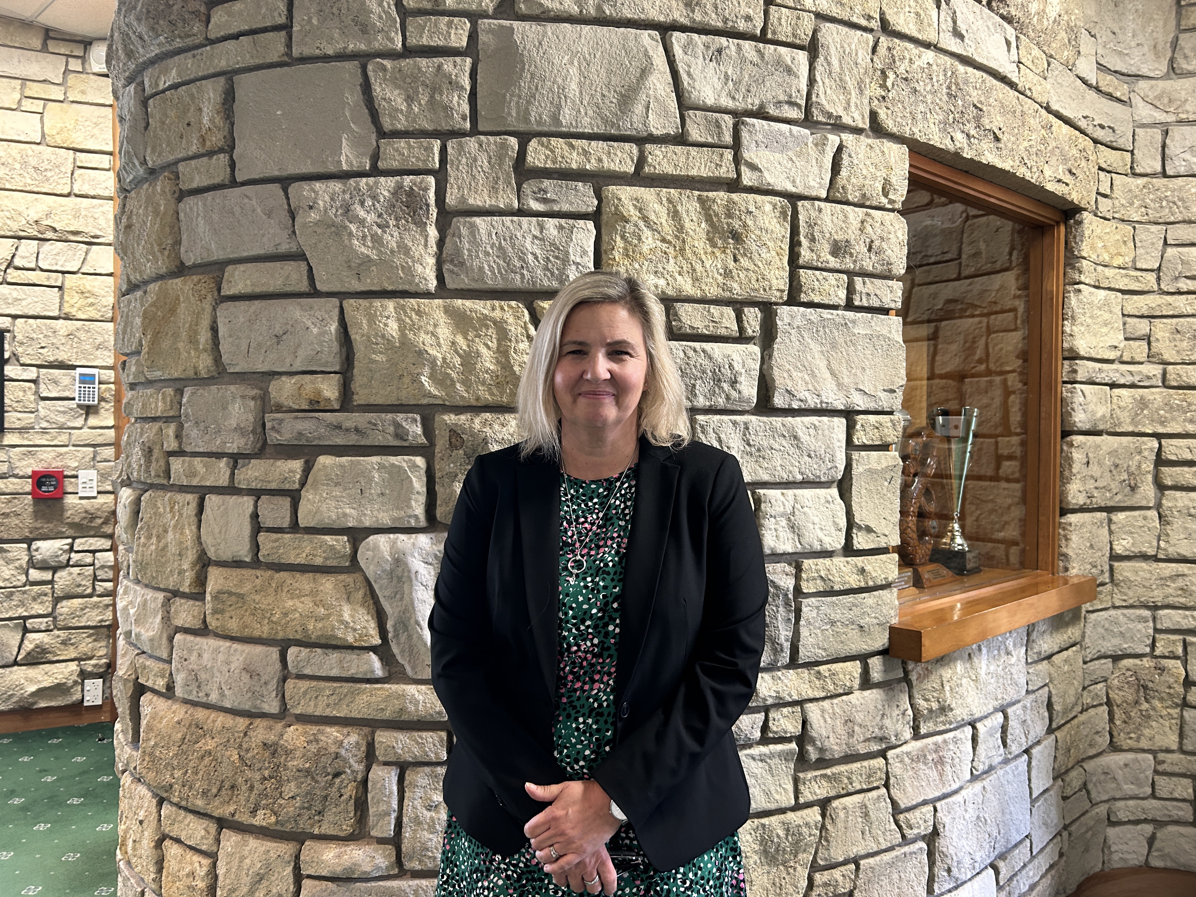 Director of Curriculum standing in the Dilworth Senior Campus Foyer