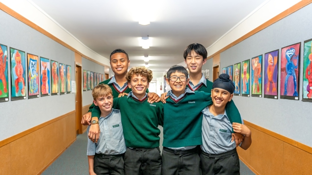 boys standing with each other in a hallway 