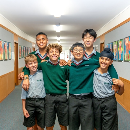 boys standing with each other in a hallway 