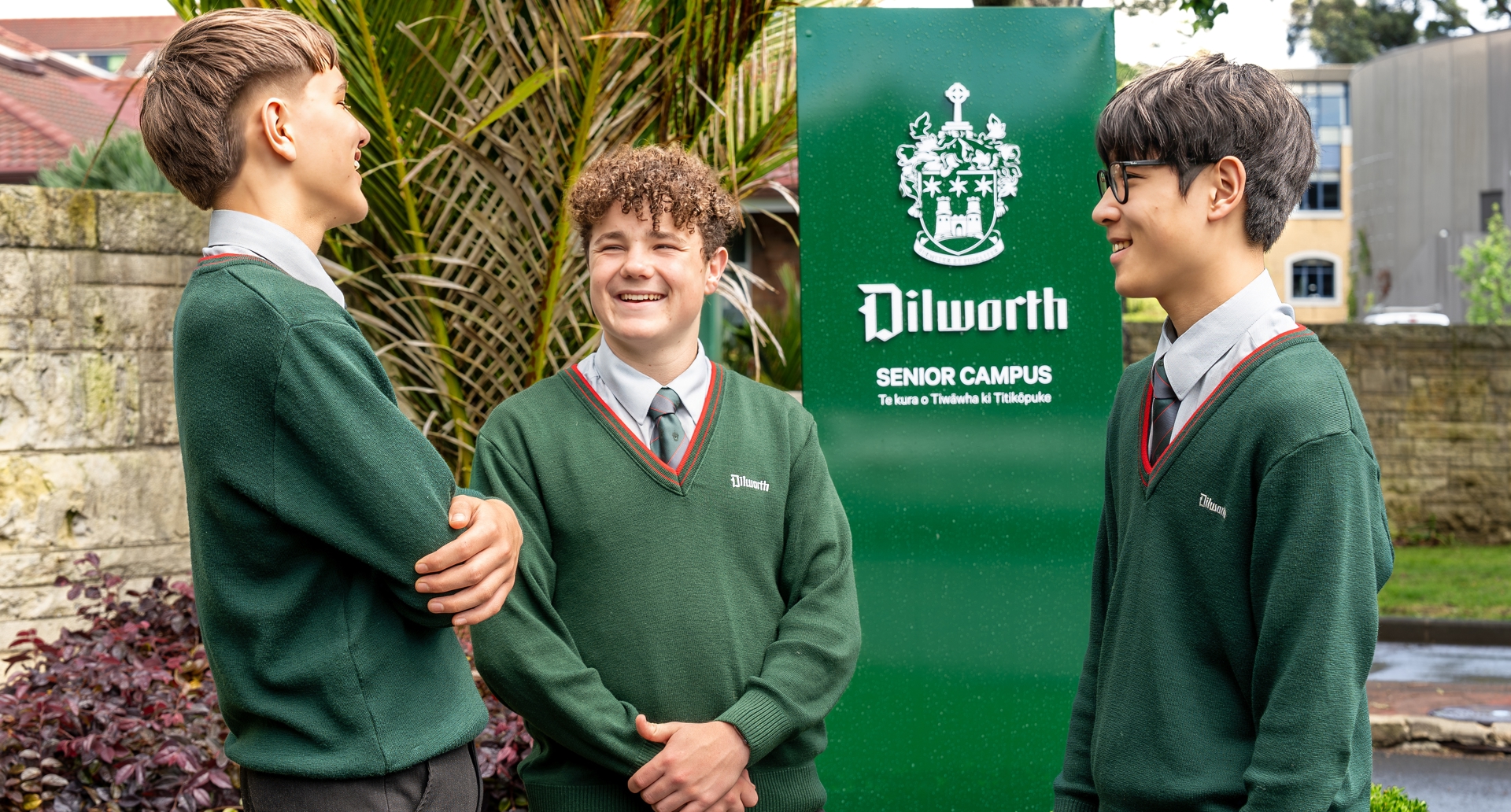 boys standing and talking by the Dilworth sign