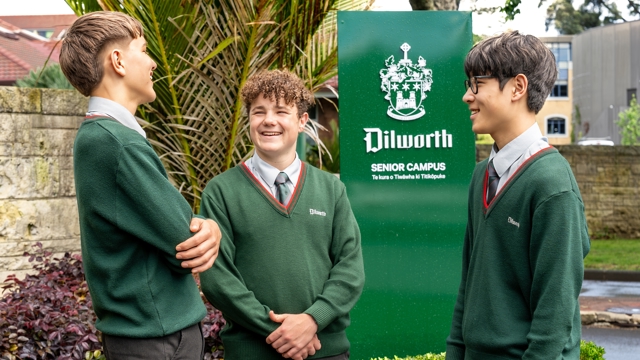 boys standing and talking by the Dilworth sign